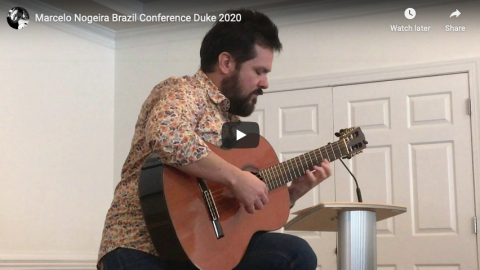 Marcelo Nogeira plays guitar during session of DBI conference